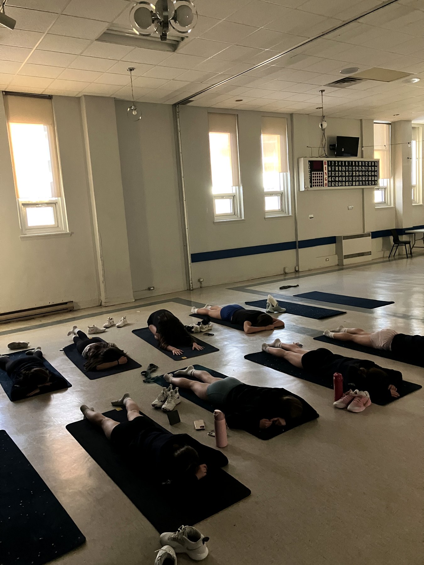 Groupe allongé sur des tapis dans une salle de pratique restaurative.
